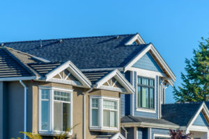 The top story of a house with beautiful windows